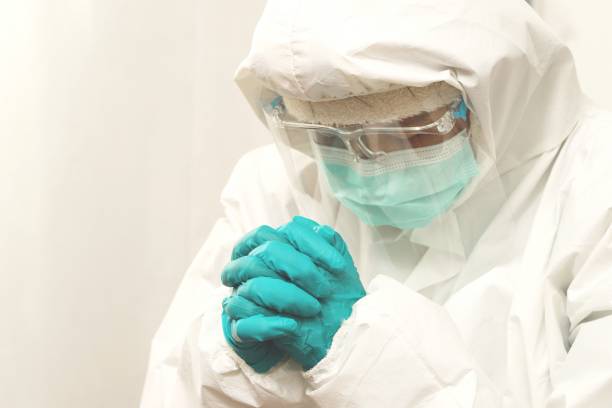 istock Nurse wearing PPE in treatment room 1336978895