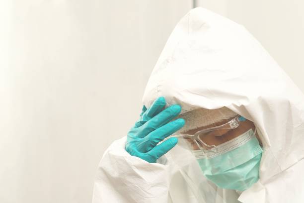 istock Nurse wearing PPE in treatment room 1336978903