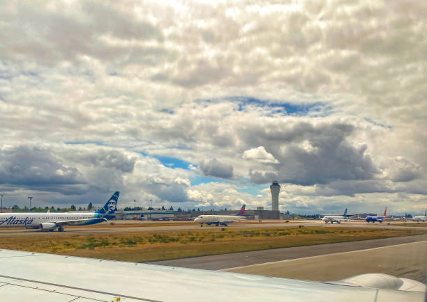 Seattle,, USA - Mar 8, 2019: A passing Alaska airlines plane at SeaTac headed in to a gate late in the day.