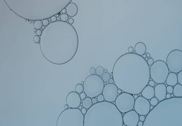 istock Abstract oil droplets on water creative art image and pattern on light blue background. 1336983642