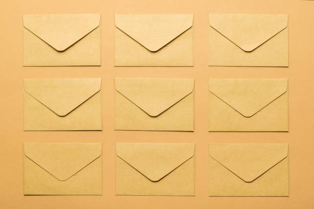 istock Top view of several paper envelopes on a paper background. Flat lay. 1336988255