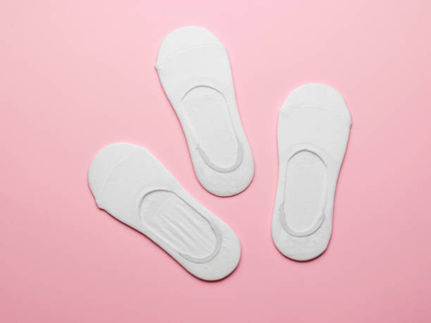 istock White women's socks on a pink background. Flat lay. 1336988256
