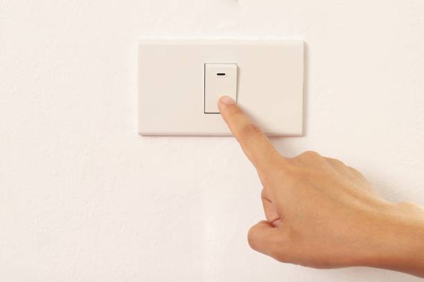 istock woman using index finger to turn off the light 1336989017