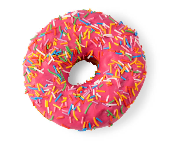 istock A donut covered with pink icing and chocolate chips isolated on a white background 1336989697