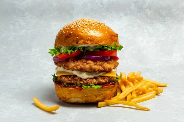 istock Big doubleburger with breaded chicken cutlet and fries 1336993504