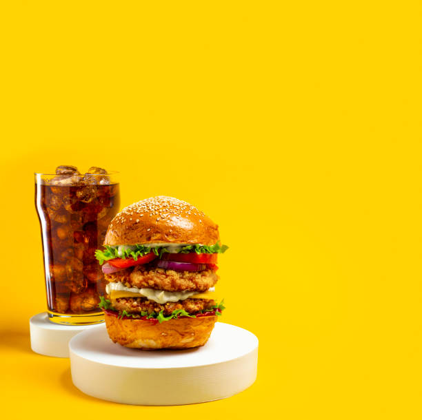 istock Delicious hamburger with cola on a yellow background 1336993720