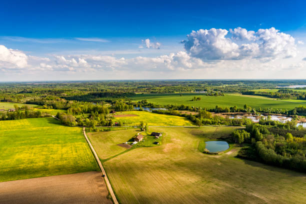 Aerial view of Latvia countryside in beautiful spring day Aerial view of Latvia countryside with fields and Farmstead building in beautiful spring day latvia stock pictures, royalty-free photos & images