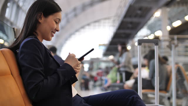 Woman using smart phone at the airport