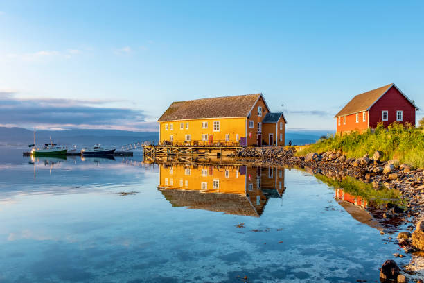 Lofoten Islands Midnight sun over yellow fishing houses midnight sun stock pictures, royalty-free photos & images