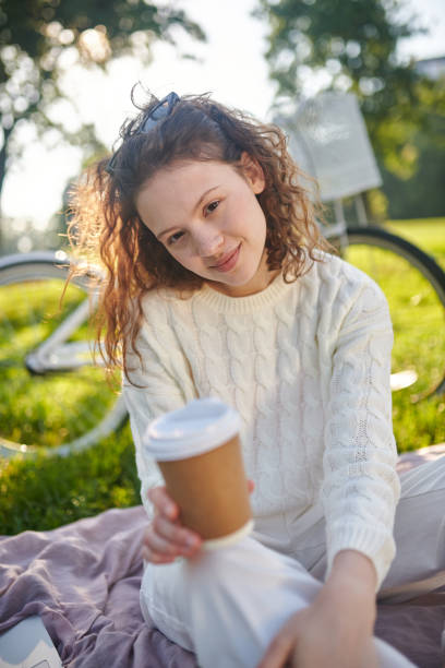 istock A young girl with a coffee cup looking realed 1336995774
