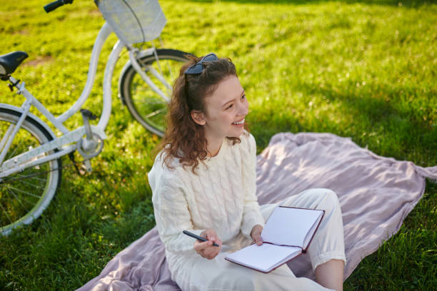 istock A young girl with a diary in hands thinking and making notes 1336995852
