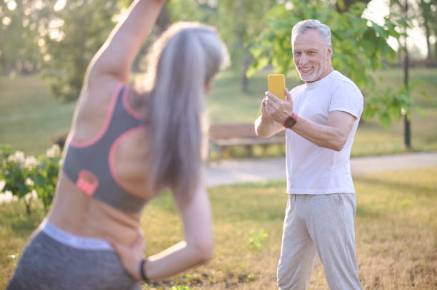 istock A man making a picture of his wife while she exercising 1336998292