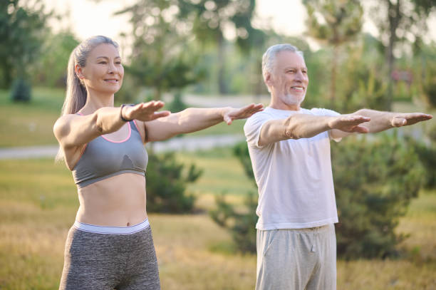 istock A mature couple exercising in the park 1336998389