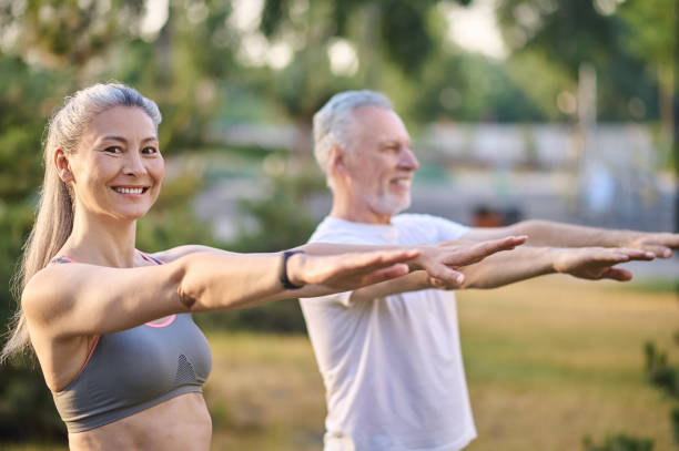 istock A mature couple exercising in the park 1336998396