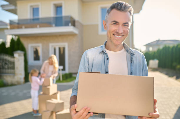 istock Smiling man carrying things in box on street 1337001399