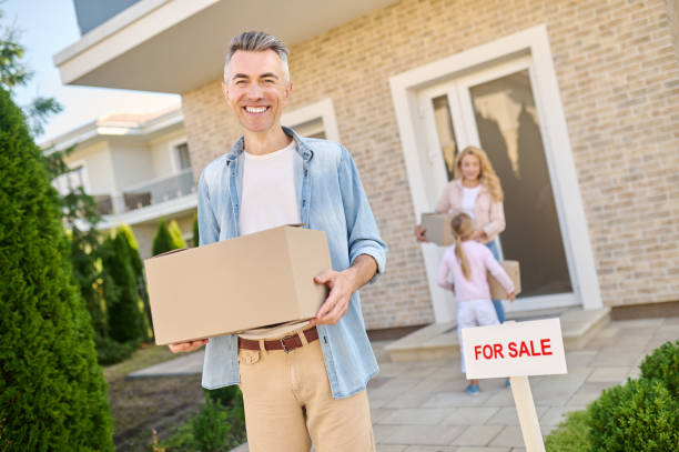 istock Smiling man taking the box out of house 1337001435