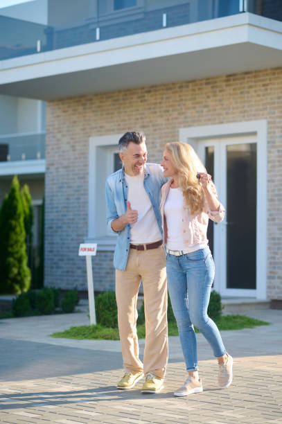 istock Laughing happy man and woman with keys 1337001442