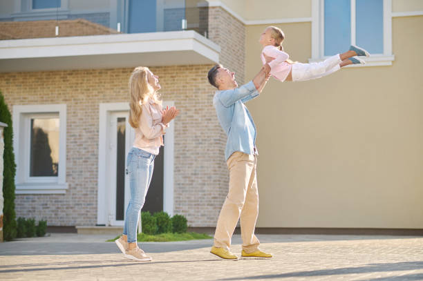 istock Dad raised his little daughter in arms up 1337001484