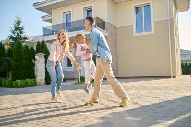 istock Dad and mom playing with daughter on street 1337001488