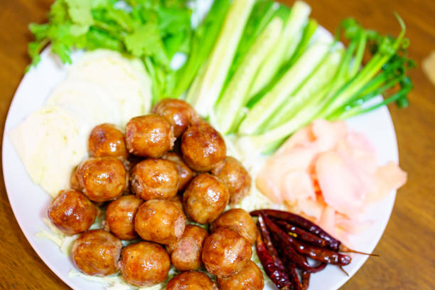 Thai fried sausages decorated in a plate, ready to eat.