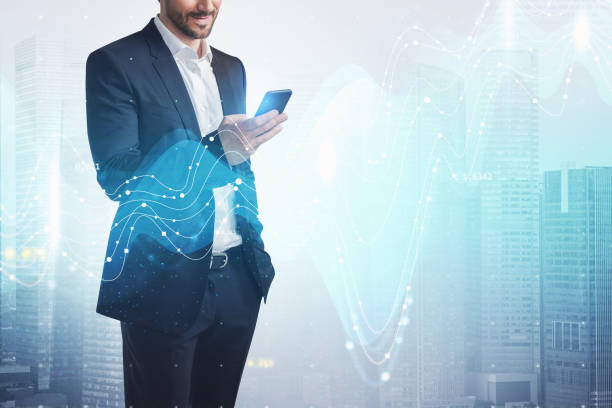 istock Smiling businessman using smartphone in city 1337006322