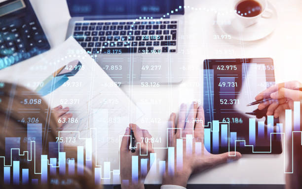 istock Top view of two business partners trader hands working together to develop new trading strategy. Stock market changes, business bar graph. Concept of internet trading 1337007269