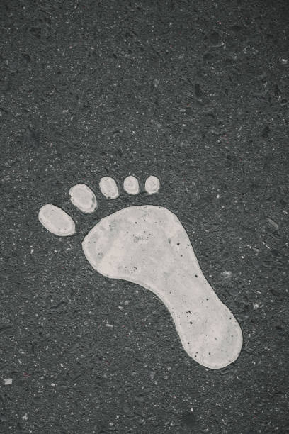 istock Painted Footprint On Asphalt . Vertical shot , close up 1337012774