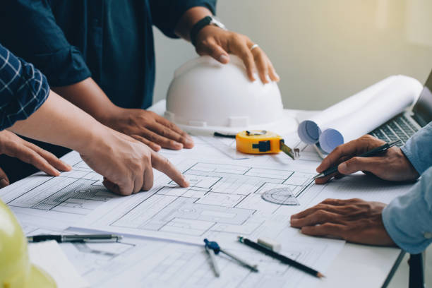 istock Engineer or architect meeting for project working with partner and checks construction blueprints on new project with engineering tools in working site. 1337013717