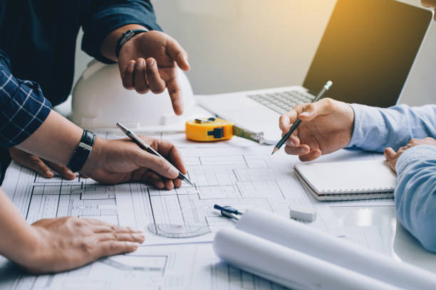 istock Engineer or architect meeting for project working with partner and checks construction blueprints on new project with engineering tools in working site. 1337013718