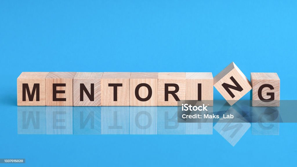mentoring word is made of wooden building blocks lying on the yellow table, concept mentoring word written on wood block. reduction word is made of wooden building blocks lying on the yellow table. Business concept Mentorship Stock Photo