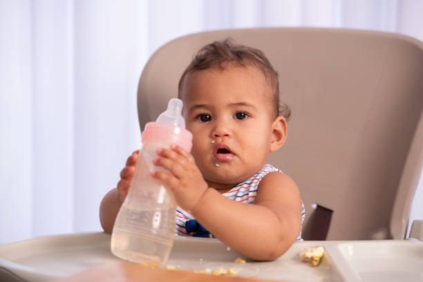 istock Adorable baby drinking water. 1337015039