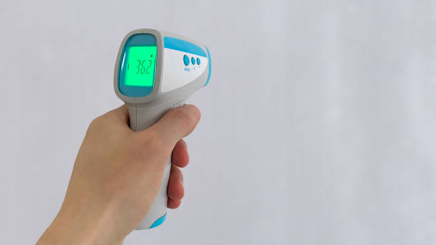 istock Non-contact thermometer held in the left hand 1337015117