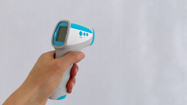 istock Non-contact thermometer held in the left hand 1337015129