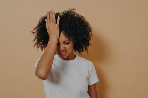 istock Tired stressful dark skinned woman keeping hand on forehead suffering from head migraine 1337016201