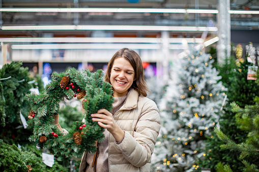 Young adult woman at Christmas retail shop