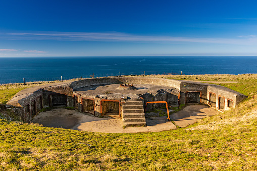 This July 2021 image of a WWII gun platform was taken along the Awaroa Godley Head Loop Track, a part of Horomaka Banks Peninsula in Ōtautahi Christchurch, Aotearoa New Zealand. The historical defence position overlooks Te Moana-nui-a-Kiwa Pacific Ocean near the entrance to Te Whakaraupō Lyttelton Harbour.