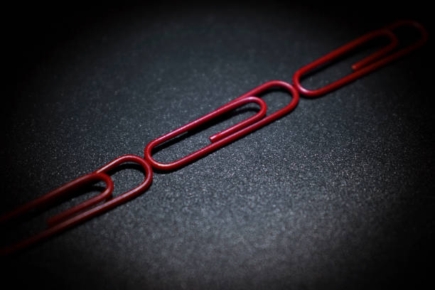 istock red paper clips lying on a metal surface 1337018702