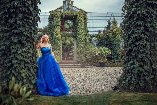 A beautiful blonde princess in a secret garden setting
