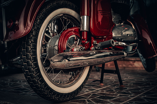 Red motorcycle. Motorcycle wheel close up. Retro style.