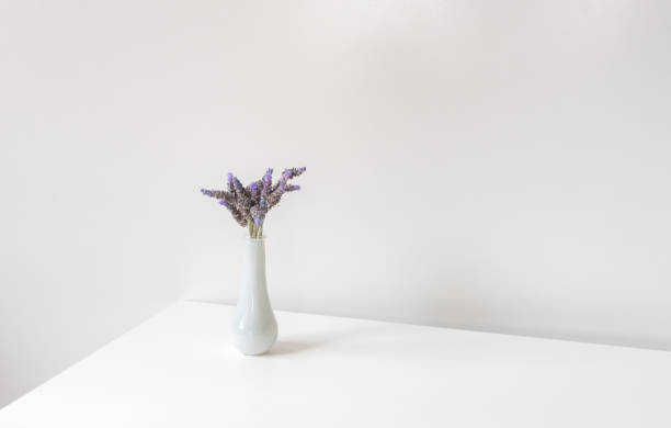 istock Small white vase with lavender on shelf - minimalist nature concept 1337021789