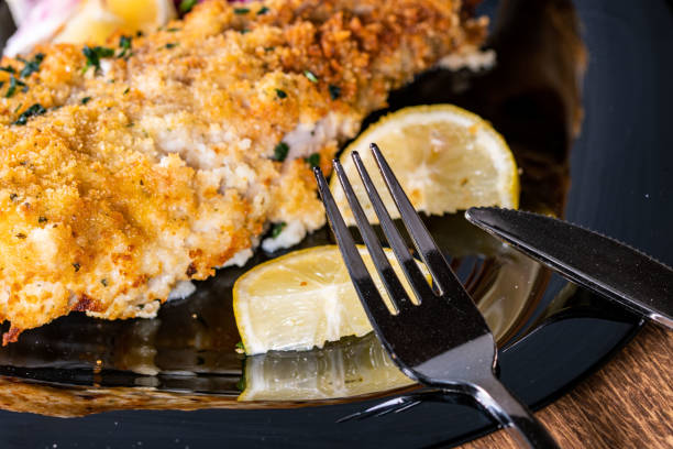 istock cutlery on a plate of breaded fish 1337022489