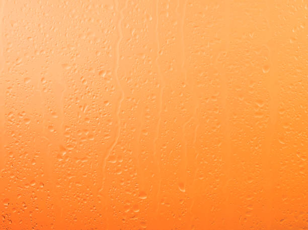 istock Raindrops on glass window over sunset sky 1337027193