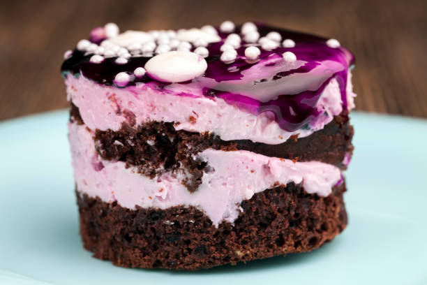 istock chocolate cake with cream covered with blueberry jam 1337028164