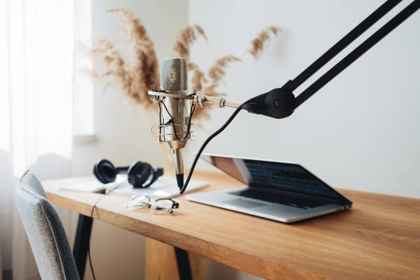 istock Broadcast studio. Podcast interior. Tiny room for podcaster. Microphone and laptop on the table