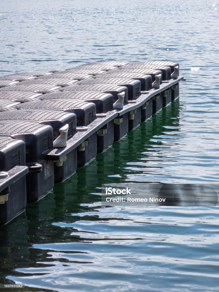 Small plastic pier on the lake Color Image Stock Photo