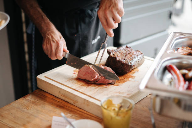 istock Cook cutting meat at a barbecue 1337032346