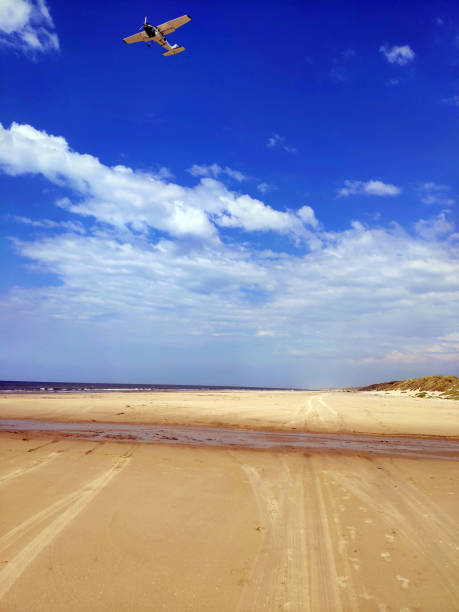 istock airplane landing on North Sea beach 1337033673