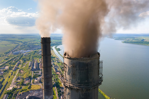 Smoke comes out of the chimney into the blue sky