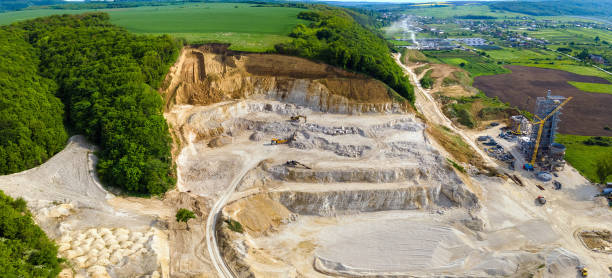 istock Open pit mining of construction sand stone materials with excavators and dump trucks. 1337038837