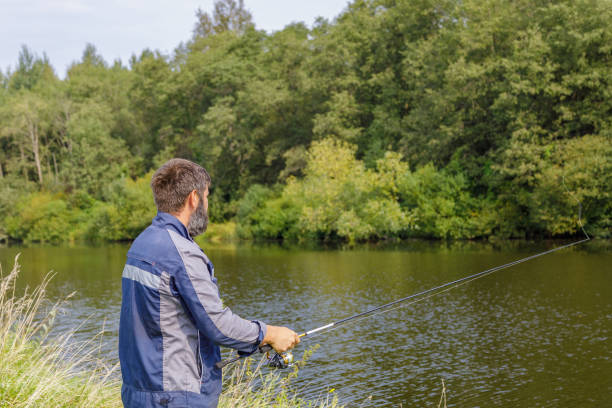 istock A man with a beard is fishing on the river. 1337042123